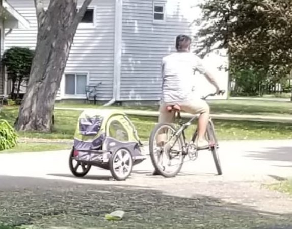 Man posed on bike with trailer attached